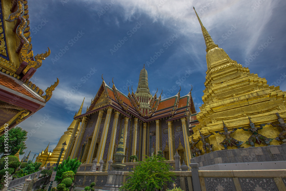 Naklejka premium Temple of the Emerald Buddha - Wat Phra Si Rattana Satsadaram / Wat Phra Kaew-Bangkok: June 13, 2020, tourists visit to see the beauty of The Grand Palace, in Phra Nakhon District, Thailand.