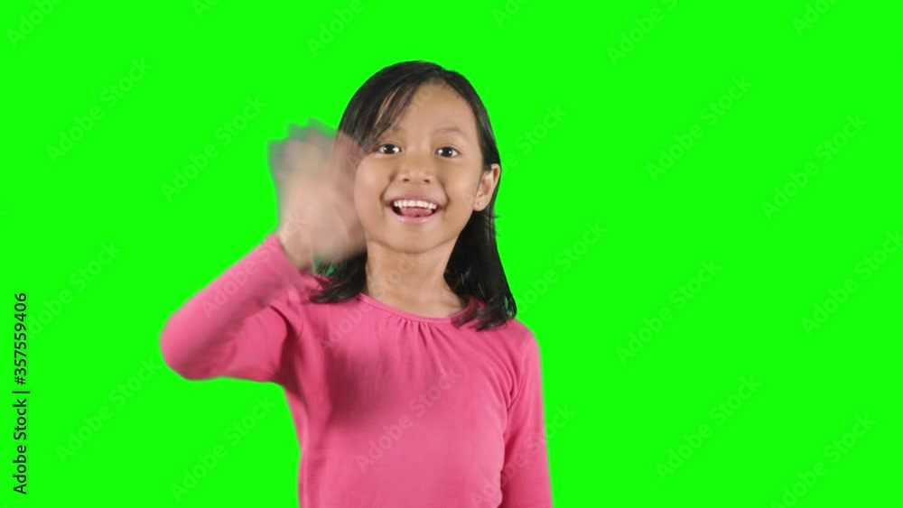 Cute little girl waving hands in the studio Cute little girl waving hands in the studio