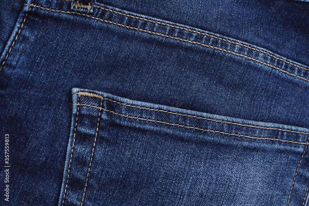Close up of jeans fabric in a jeans pant. Jeans fabric texture. Close up of jeans fabric in a jeans pant. Jeans fabric texture.