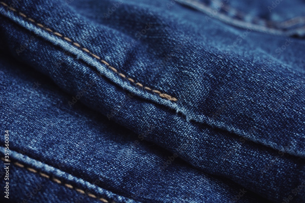 Fototapeta premium Close up of jeans fabric in a jeans pant. Jeans fabric texture.