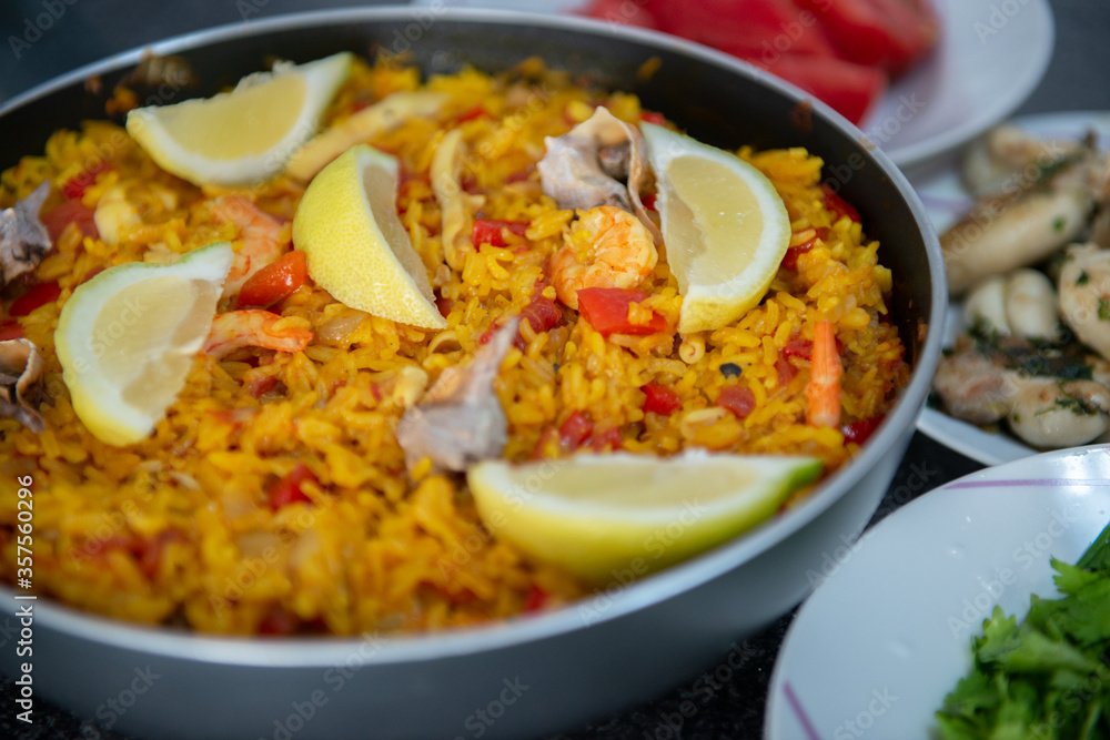 Seafood paella, traditional spanish food. Pan full of rice cooked with vegetables, shellfishs and shrimps