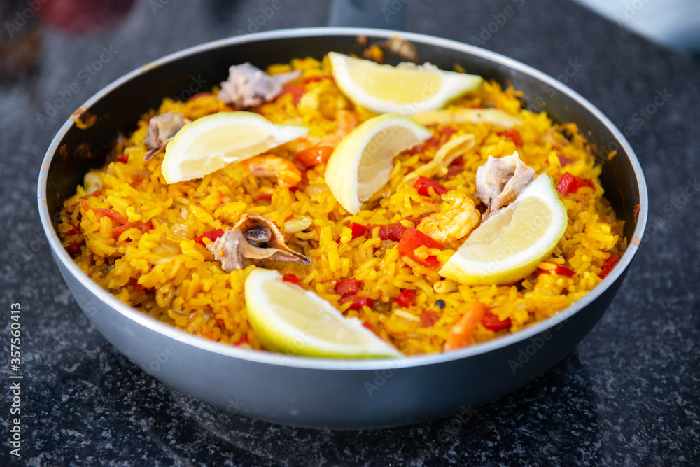 Seafood paella, traditional spanish food. Pan full of rice cooked with vegetables, shellfishs and shrimps. Traditional spanish food Seafood paella, traditional spanish food. Pan full of rice cooked with vegetables, shellfishs and shrimps. Traditional spanish food
