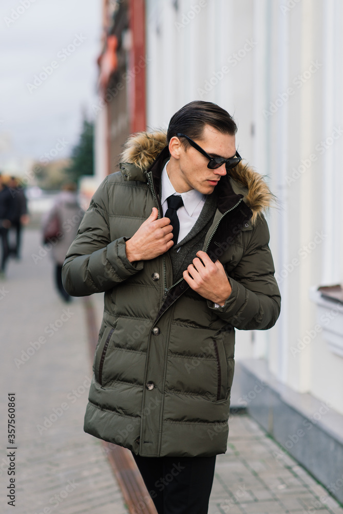 Man in a stylish suit. Businessman in an autumn city, fashion Man in a stylish suit. Businessman in an autumn city, fashion