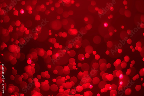 Red glitter vintage lights background. Red bokeh on black background.