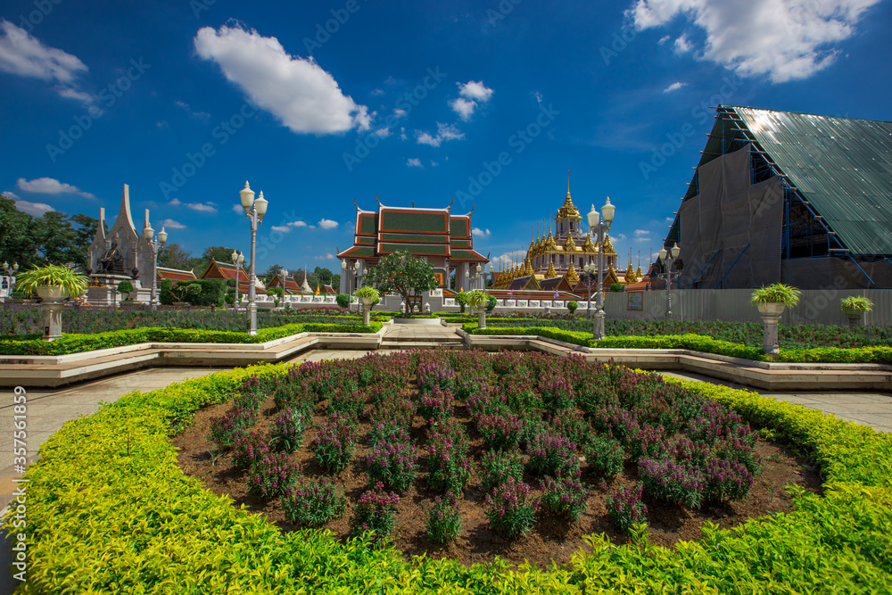 Background of tourist attractions where people come to see the beauty of the architecture of the golden pagoda in Bangkok (Wat Metal Prasat Or Wat Ratchanaddaram Worawihan) in Thailand