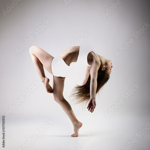 Young beautiful graceful woman with perfect slim sporty body dancing and jumping. Female beautiful contemporary dance. Ease of movement, youth, grace, joint pain relief and movement 