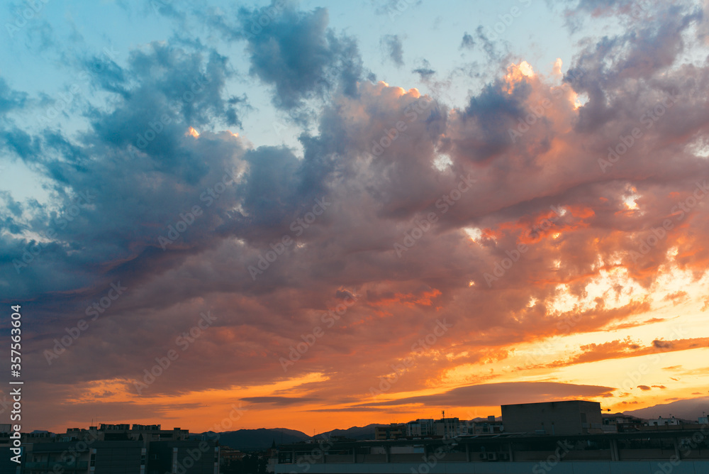 Beautiful sunset sky above clouds with dramatic light. Blue and orange colours. Beautiful sunset sky above clouds with dramatic light. Blue and orange colours.