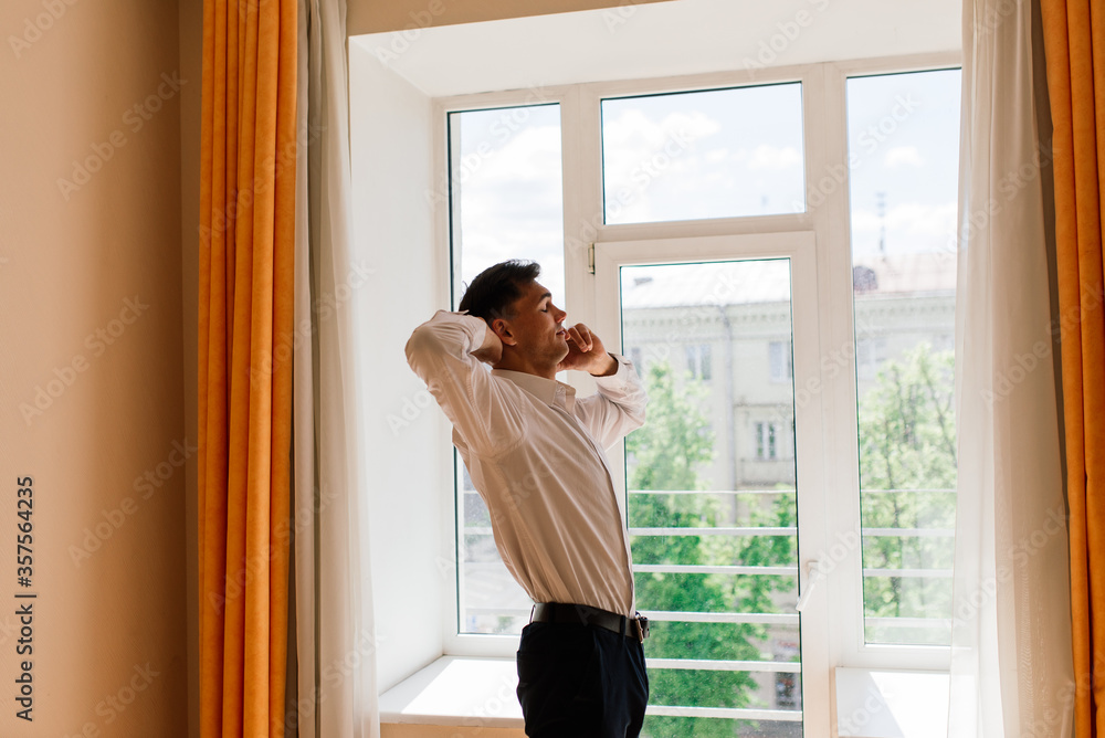 Relaxed young man resting from work. Man enjoy break stretching in home office workplace, isolation Relaxed young man resting from work. Man enjoy break stretching in home office workplace, isolation