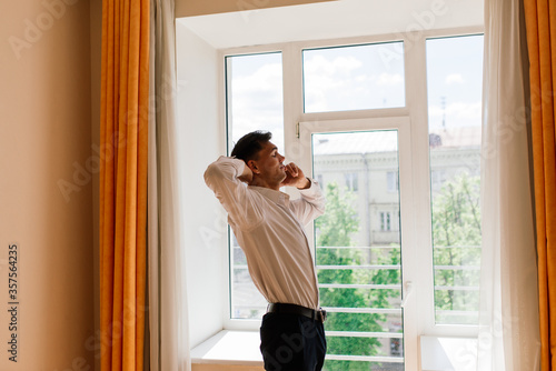 Relaxed young man resting from work. Man enjoy break stretching in home office workplace, isolation Free Download Relaxed young man resting from work. Man enjoy break stretching in home office workplace, isolation - GFXLoad