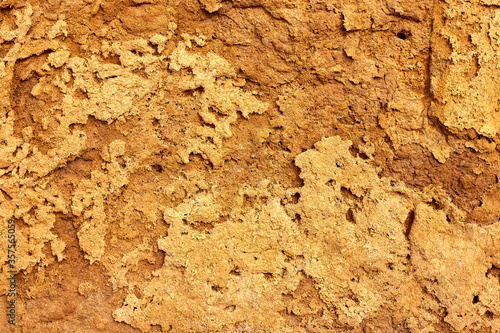 Texture of different layers of clay on the edge of a cliff. Closeup