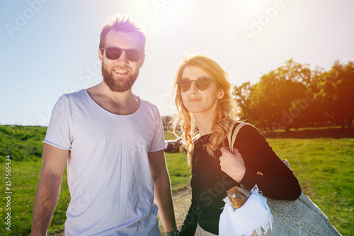 Portrait of two people holding hands on the road to picnic outdoors photo