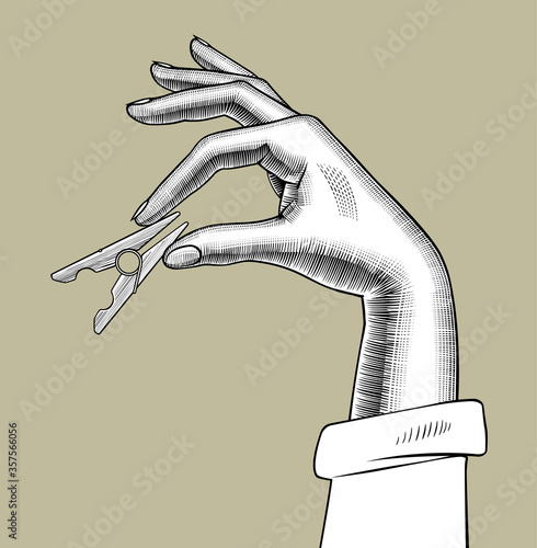 Engraved drawing of a female hand with a clothes pin in the fingers