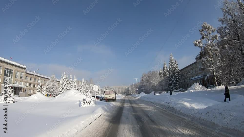 Novosibirsk Academgorodok in winter. Driving on a snowy Koptyug Avenue along Institute of Cytology and Genetics Novosibirsk Academgorodok in winter. Driving on a snowy Koptyug Avenue along Institute of Cytology and Genetics