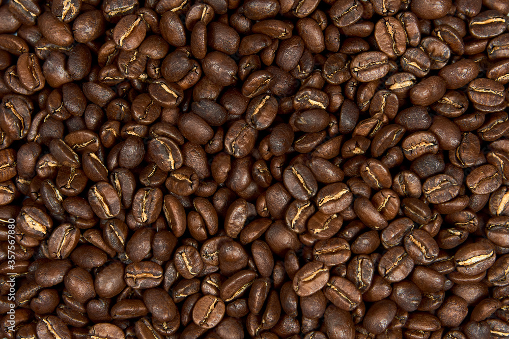 Fototapeta premium Caffeine, raw and agriculture concept. Close up roasted coffee beans background.