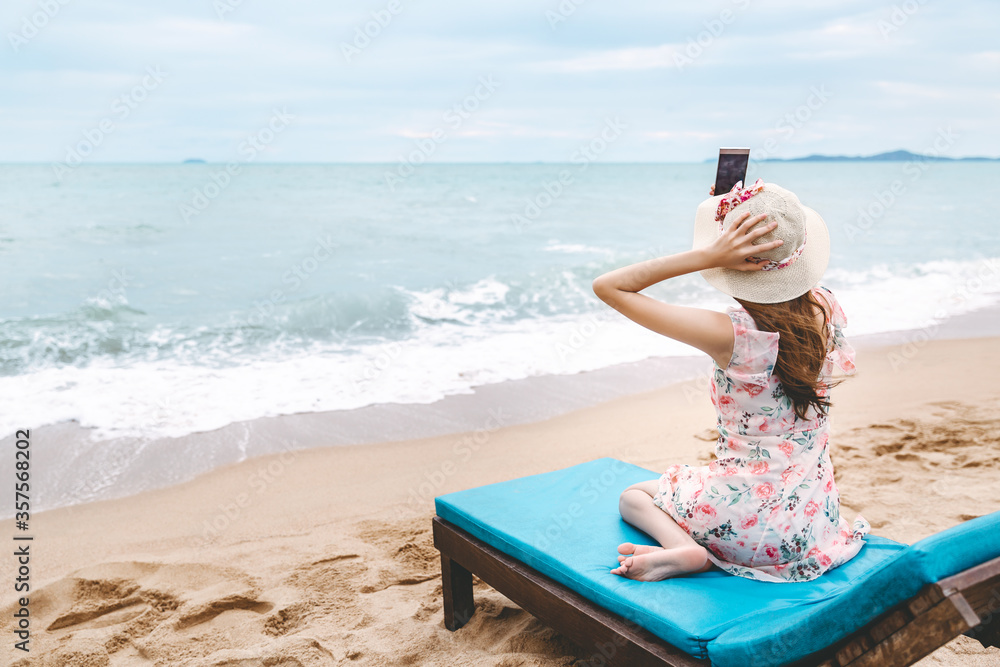 Traveler asian woman selfie with mobile phone on Thailand beach