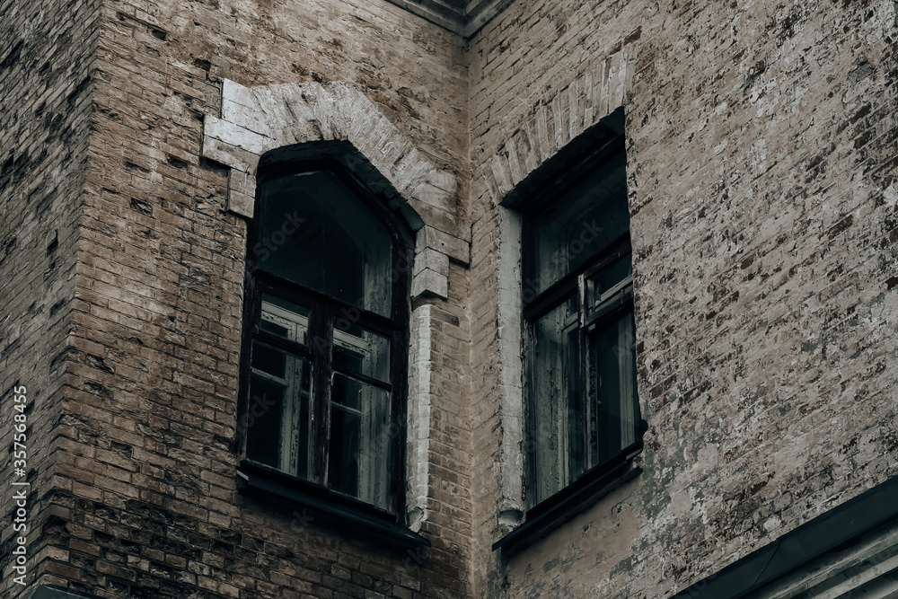 Old brick wall with beautiful windows on an abandoned building Old brick wall with beautiful windows on an abandoned building