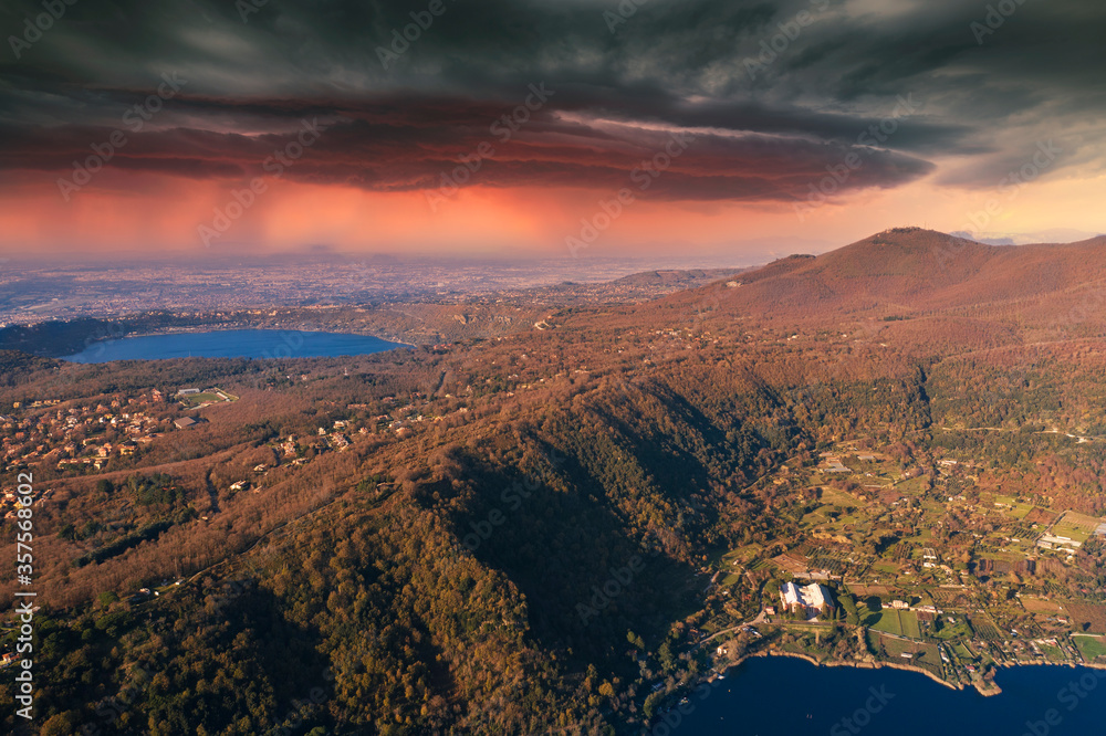 view of the roman castles with the lake of nemi and castel gandolfo and in the background a thunderstorm 