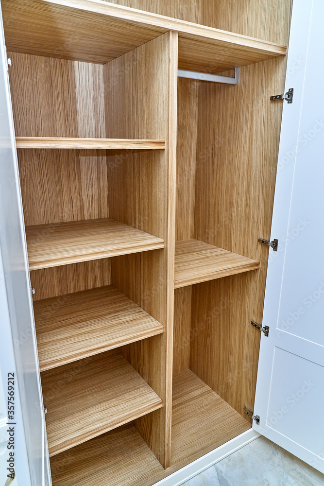 White wardrobe with wooden drawers and shelves. Wooden filling of wardrobe White wardrobe with wooden drawers and shelves. Wooden filling of wardrobe