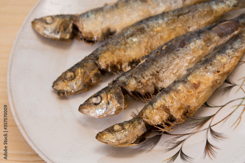 roasted or fried sardines on the plate roasted or fried sardines on the plate