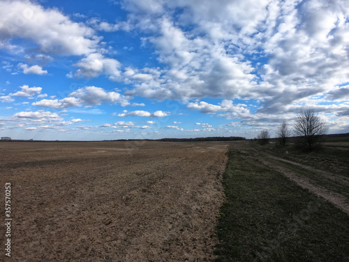 Blue sky with white clouds over farmland. Landscape.