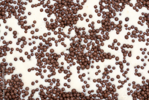 white ice cream background with brown sprinkles