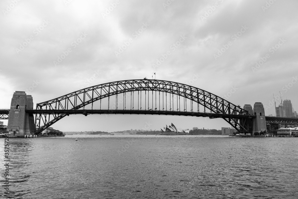 Black and white panoramic picture of the Harbour bridge and Sydney Opera house. View from the public ferry boat. Sydney, Australia