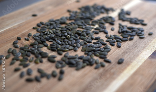 pumpkin seeds on wooden board close-up