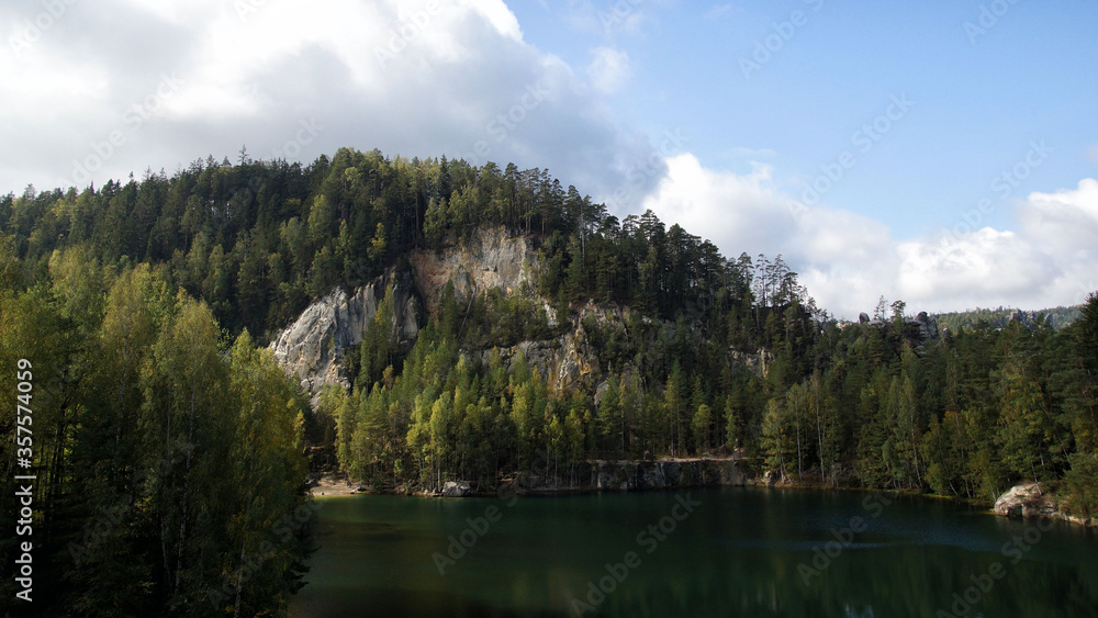 Trees on the shores of a mountain lake in The Adršpach-Teplice Rocks, Bohemia, Czech Republic, sandstone formations
