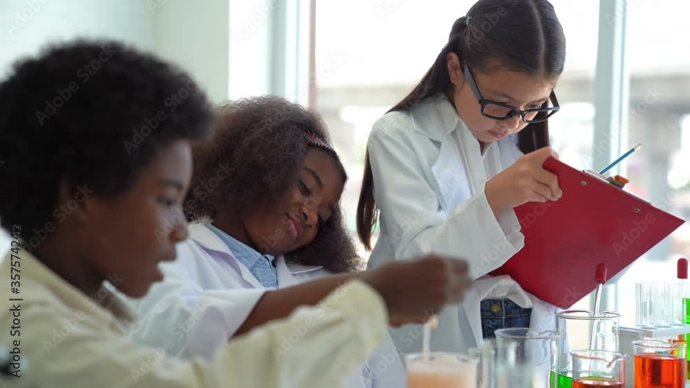 School kid or scientist studying science and experimenting with chemicals at laboratory. School kid or scientist studying science and experimenting with chemicals at laboratory.