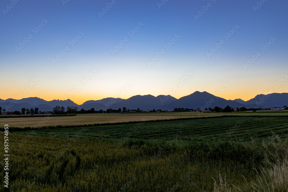 sunrise over the mountains, View Of Field Against Sky During Sunset