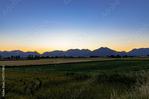 sunrise over the mountains, View Of Field Against Sky During Sunset © dhiniska