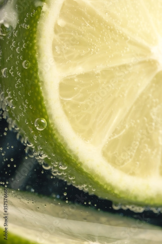 Slices of lime in a glass of soda water