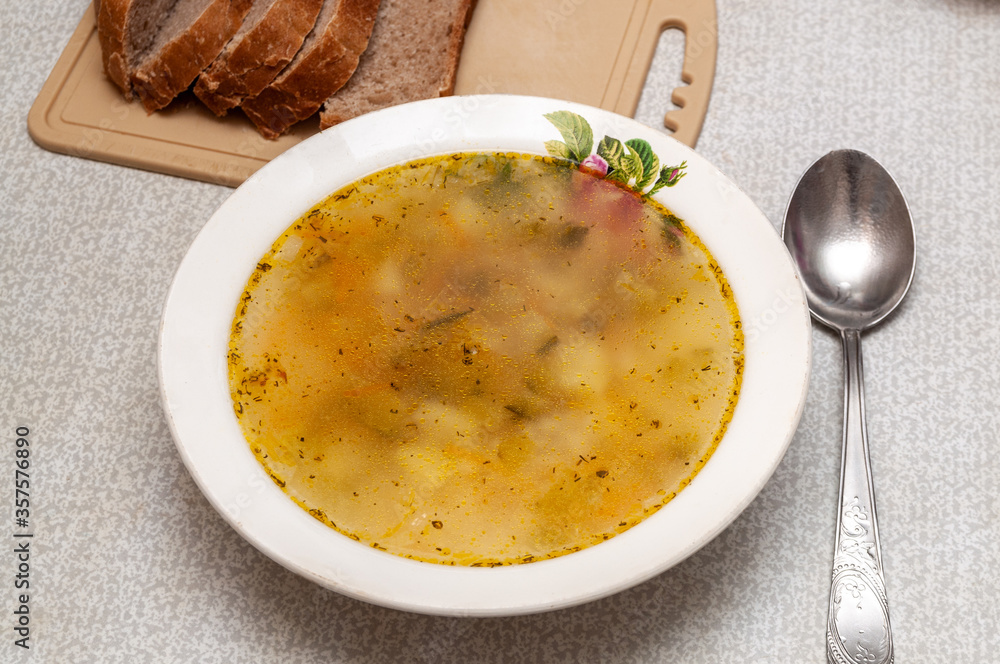 plate with soup. traditional Russian soup with pickles. rassolnik and bread. plate with soup. traditional Russian soup with pickles. rassolnik and bread.