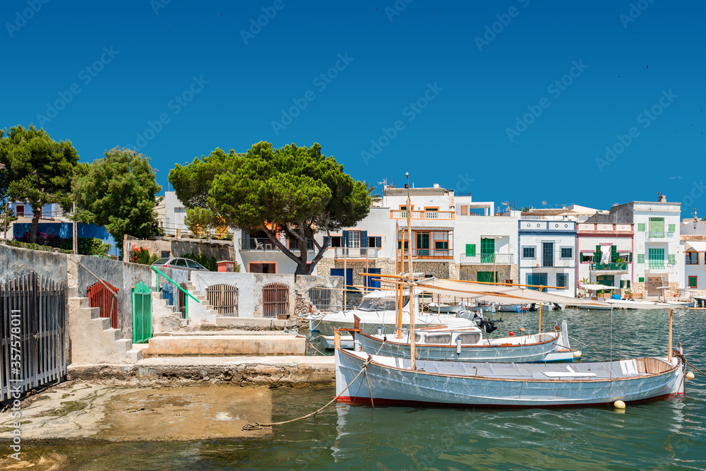 Mallorca | Boats at traditional boat houses - Barraques - in the historic port of Portocolom