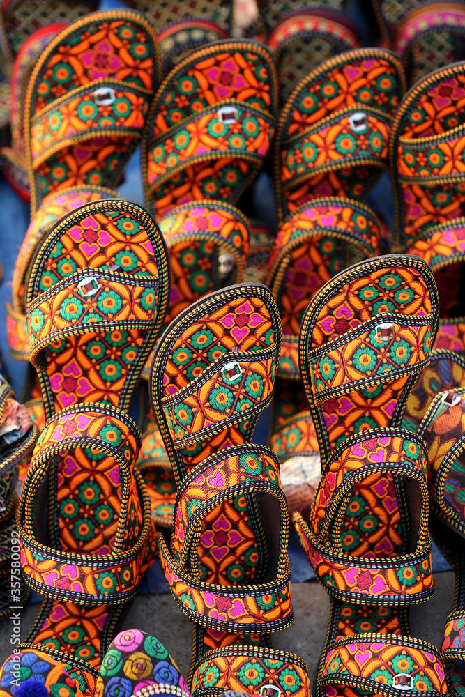 Indian traditional slippers for women. jaipur, Rajasthan India, March 2018. handmade Traditional Indian slippers. Colorful footwear. rajasthani slippers at a street market.