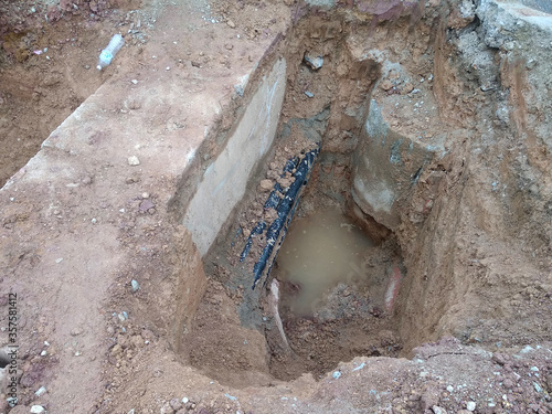 SEREMBAN, MALAYSIA -AUGUST 01, 2019: Underground utility and services pipe laid by workers in the trenches at the construction site. Installation of pipes still ongoing. 