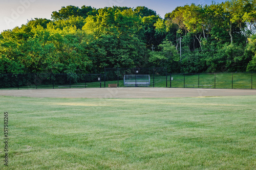 the the view from the outfield of a youth baseball field in a city park