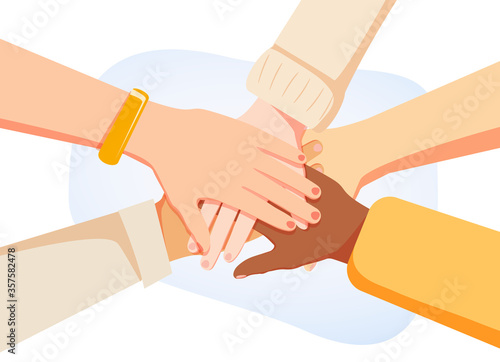 Hands of diverse group of women putting together. Concept of sisterhood, girl power, feminist community or movement