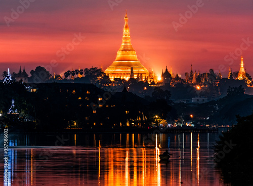 The Shwedagon pagoda at sunset from the Royal lake  Yangon