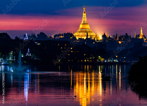 The Shwedagon pagoda at sunset from the Royal lake, Yangon