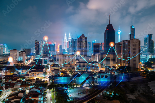 Photography Stock market graph hologram, night panorama city view of Kuala Lumpur