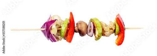 Vagan skewers of vegetables on a skewer on a white isolated background.