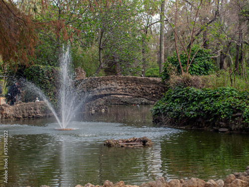 Fountain and stone bridge on the island of the ducks located within the Parque de Mar  a Luisa  Seville  Andalusia  Spain