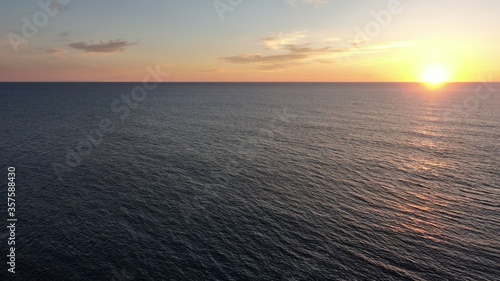 on the cliffs by the sea and the mountains watching the sunset