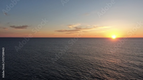 on the cliffs by the sea and the mountains watching the sunset