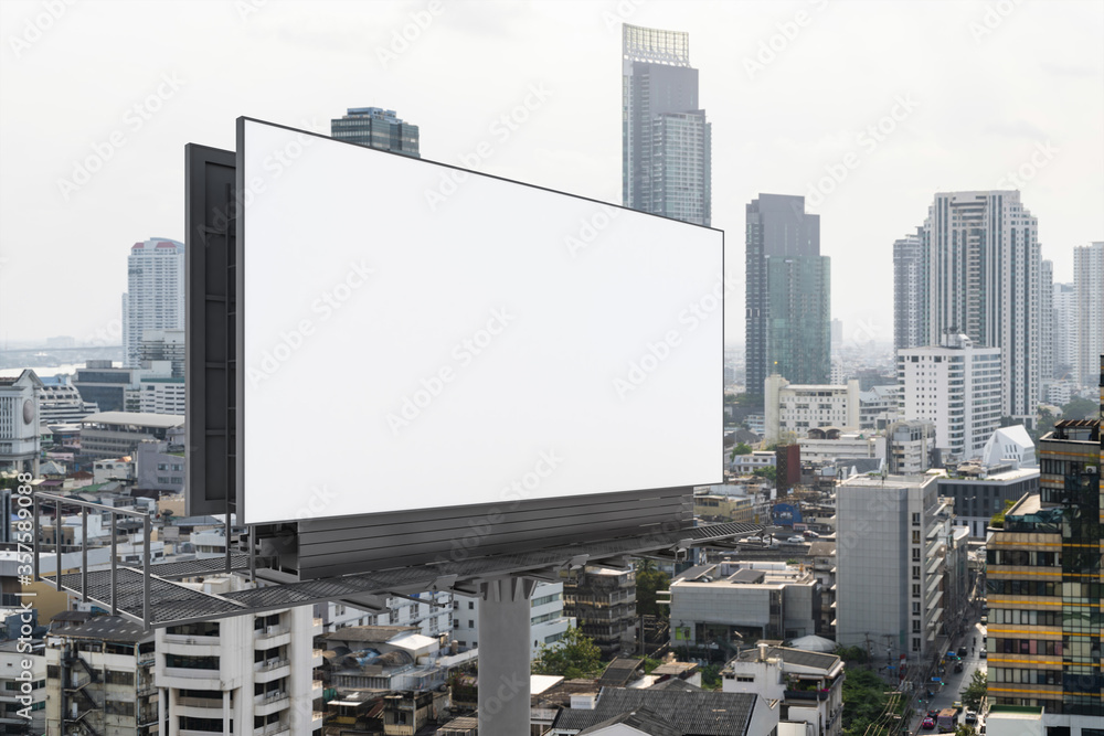 Blank white road billboard with Bangkok cityscape background at day time. Street advertising poster, mock up, 3D rendering. Side view. The concept of marketing communication to promote or sell idea. Blank white road billboard with Bangkok cityscape background at day time. Street advertising poster, mock up, 3D rendering. Side view. The concept of marketing communication to promote or sell idea.