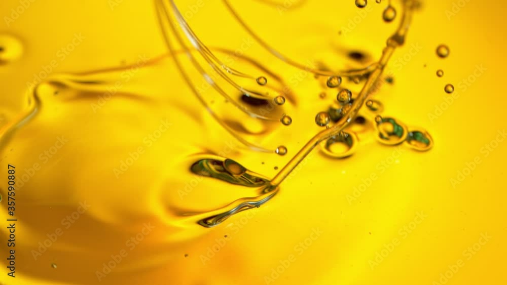 Super Slow Motion Shot of Pouring Golden Oil Liquid at 1000fps. Super Slow Motion Shot of Pouring Golden Oil Liquid at 1000fps.