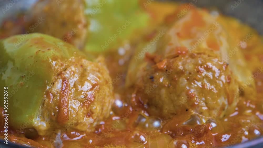 Cooking process stuffed bell peppers in a pan. Cabbage rolls are cooked in tomato sauce, close-up. Stuffed bell peppers in a pan fried in tomato sauce. Cooking process stuffed bell peppers in a pan. Cabbage rolls are cooked in tomato sauce, close-up. Stuffed bell peppers in a pan fried in tomato sauce.