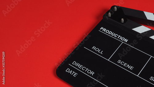 Clapper board or movie slate.It is used in video production, film, cinema industry on a red background.