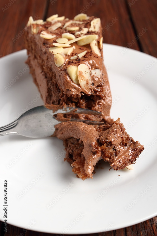 Chocolate sandwich cake garnished with flaked almonds Chocolate sandwich cake garnished with flaked almonds